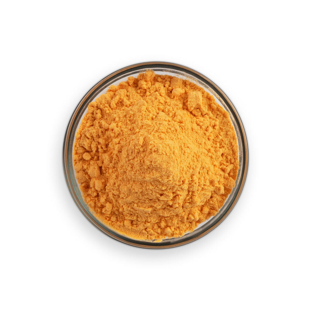 Orange powder in a glass container on a white background