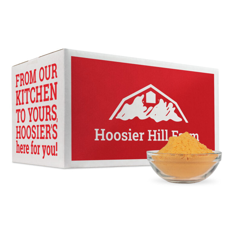 Hoosier Hill Farm product with red box and yellow powder in a glass bowl on a white background