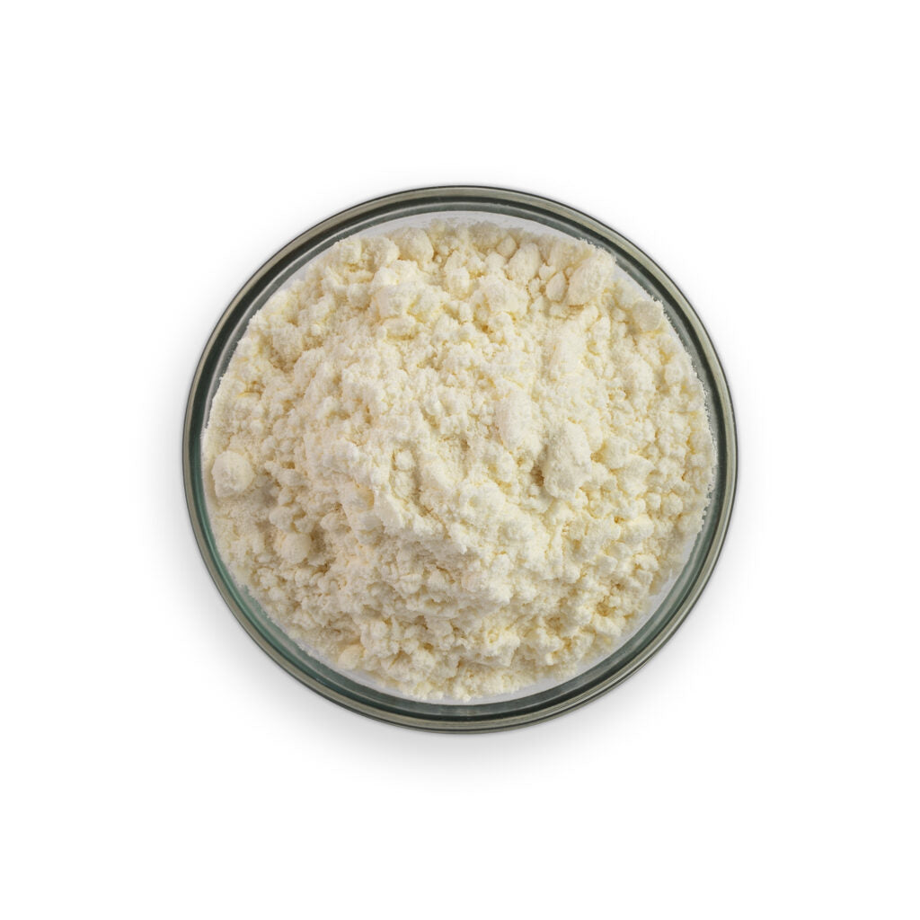 Glass bowl filled with a white powdery substance on a white background