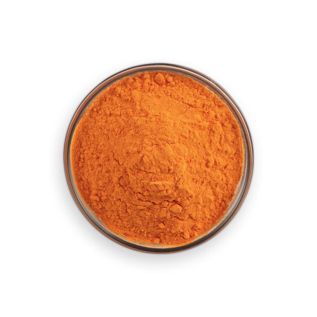 Orange powder in a glass container on a white background