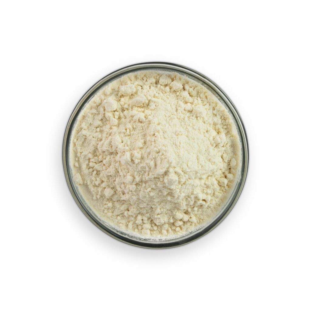 Glass bowl filled with a white powdery substance on a white background