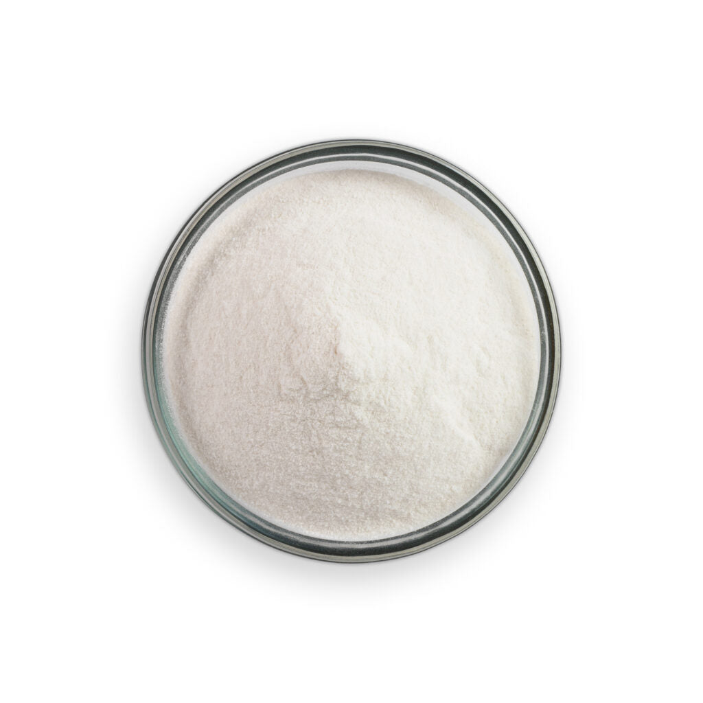Glass container filled with a white powdery substance on a white background