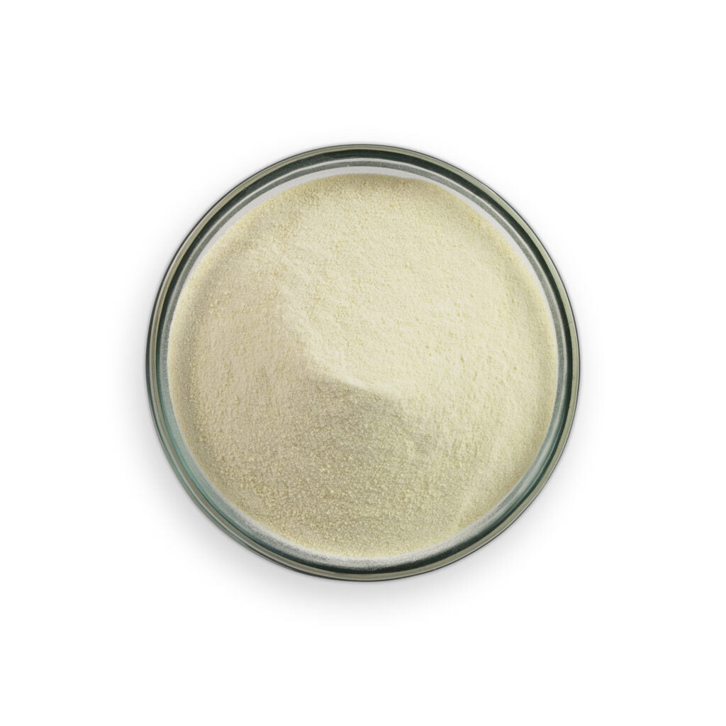 Beige powder in a glass container on a white background
