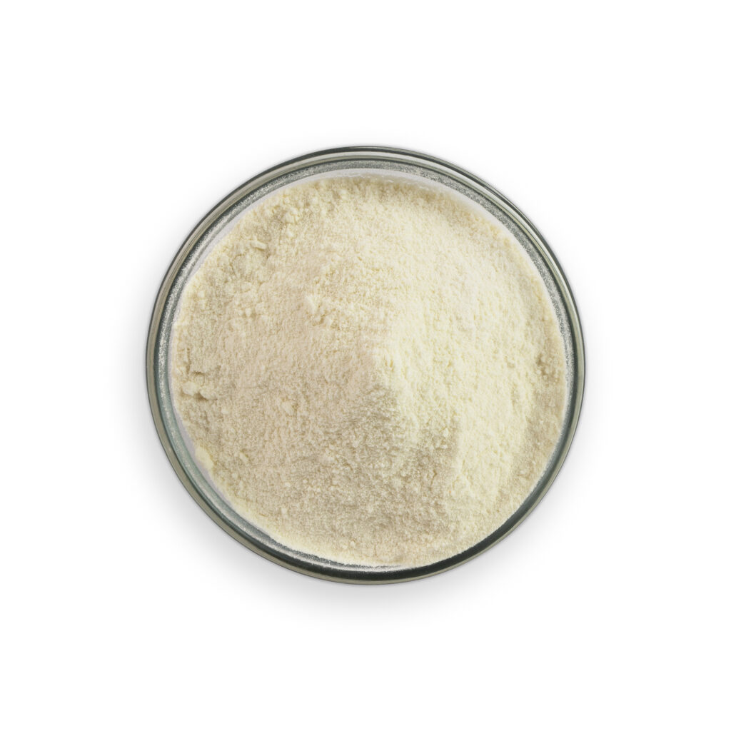 Beige powder in a glass container on a white background