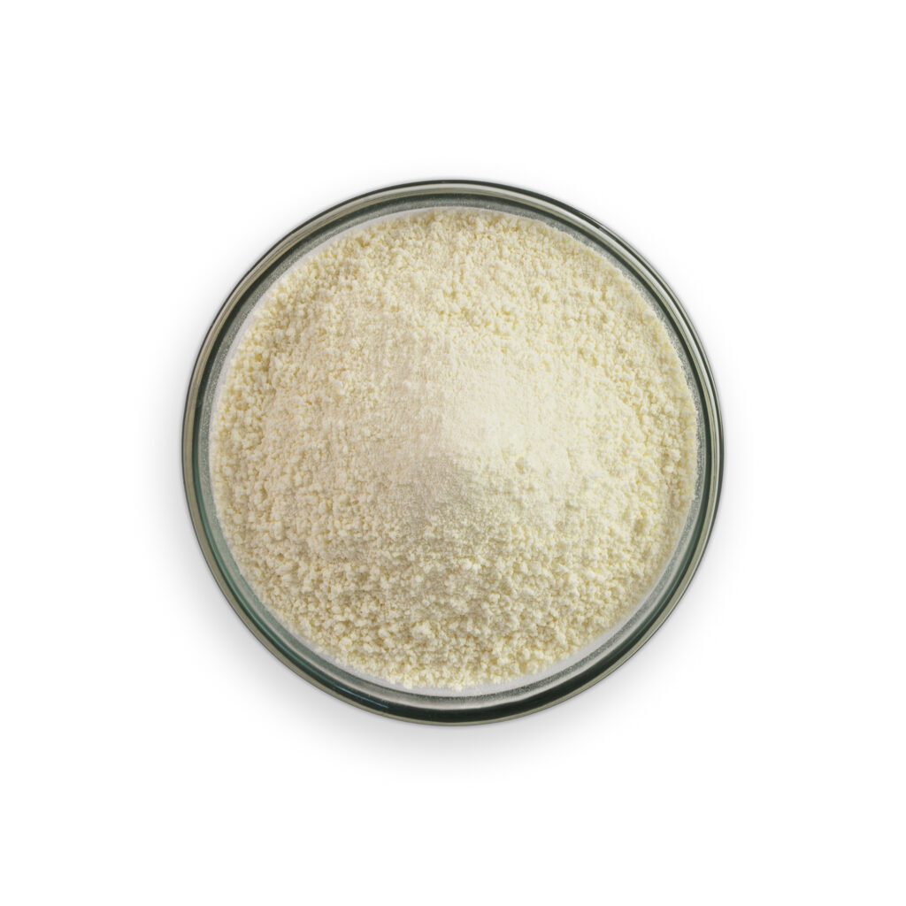 Glass bowl filled with a white powdery substance on a white background