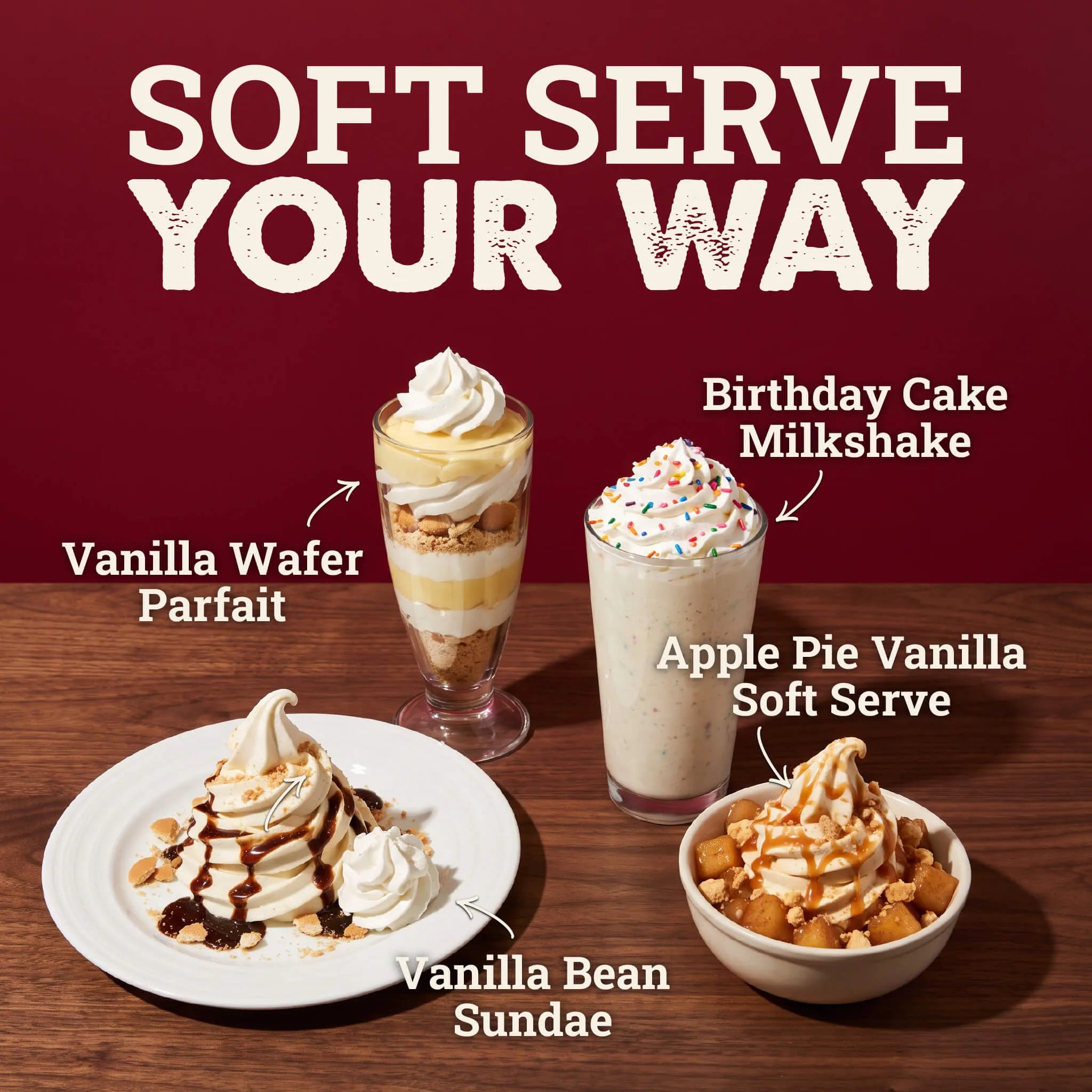 Four dessert options are arranged on a wooden table against a dark red background with large white text reading 'SOFT SERVE YOUR WAY.' The desserts include a vanilla wafer parfait in a tall glass, a birthday cake milkshake with whipped topping and sprinkles, an apple pie vanilla soft serve in a bowl, and a vanilla bean sundae on a plate.