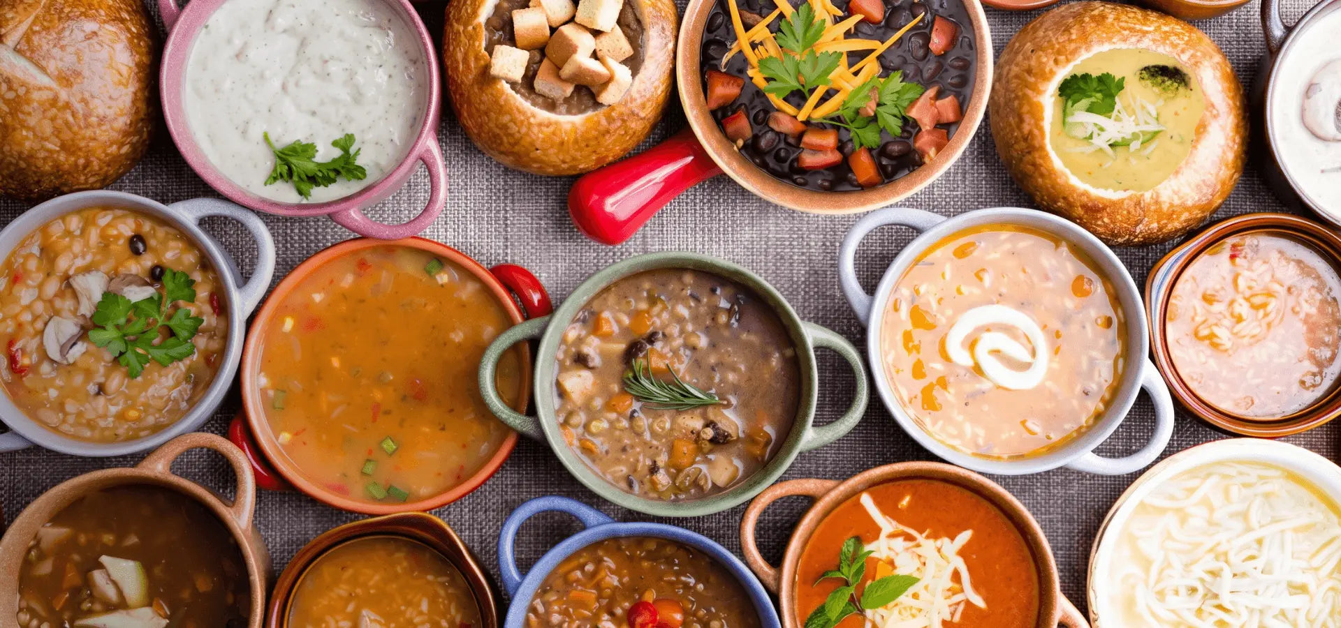 Assorted bowls of soup on a wooden table